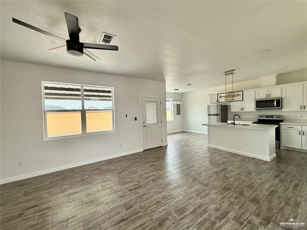 5401 North Crown Point Pharr, TX 78577 - Photo 5 of 11 a kitchen with stainless steel appliances kitchen island a refrigerator sink and white cabinets