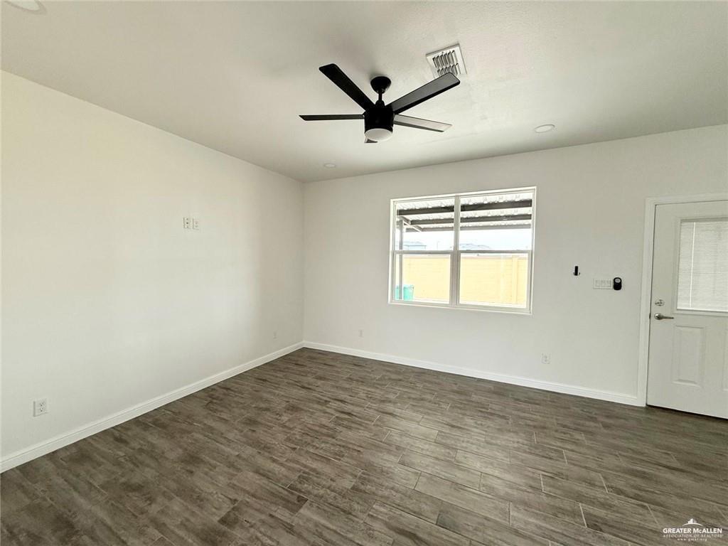 5401 North Crown Point Pharr, TX 78577 - Photo 10 of 11 an empty room with wooden floor ceiling fan and windows