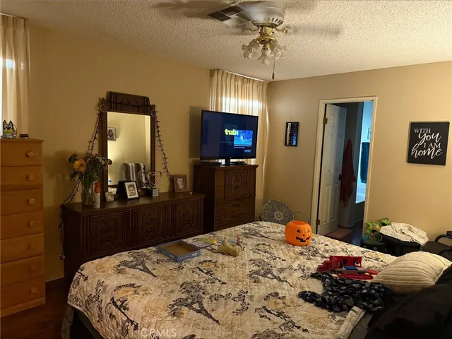 a bedroom with a bed and a dresser