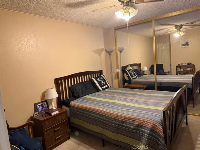 a bedroom with bed and a chandelier