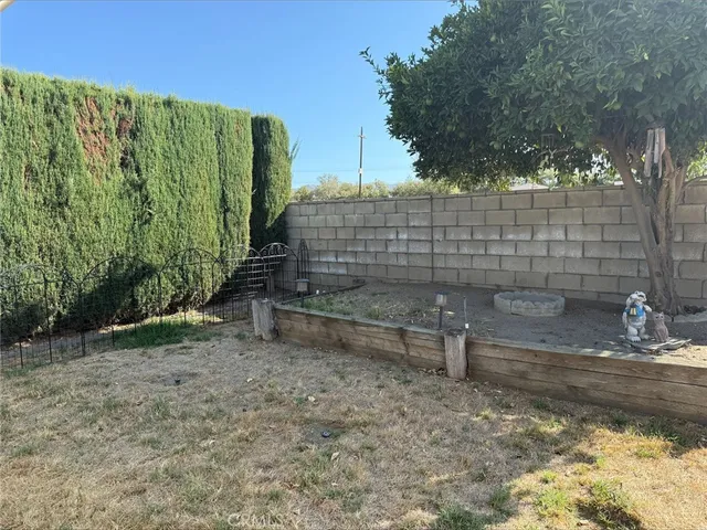 a view of a garden with wooden fence