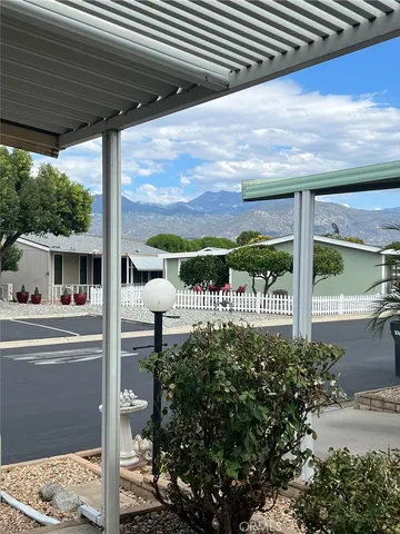 a view of a porch with furniture and garden