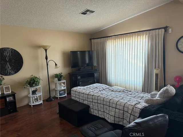 a bedroom with a bed window and a couch