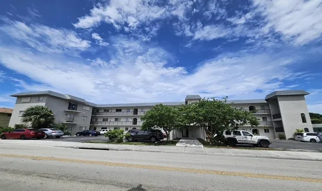a kitchen with a refrigerator and a stove top oven