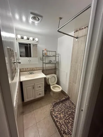 a bathroom with a sink vanity and a mirror