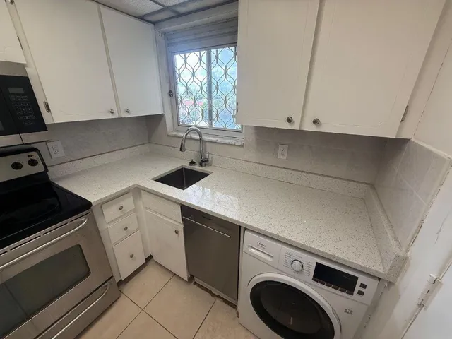 a kitchen with appliances and cabinets