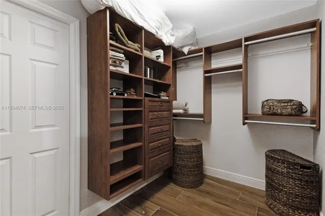 a view of walk in closet with empty racks