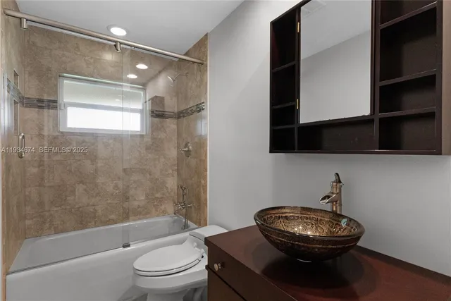 a bathroom with a toilet a sink and bathtub