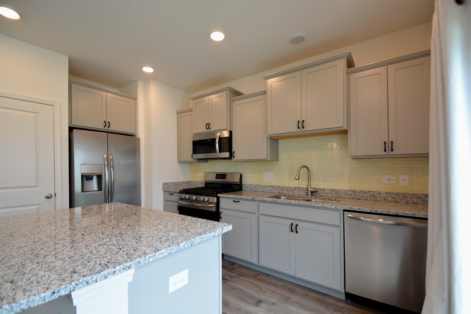 17 Grey Wolf Drive Wheeling, IL 60090 - Photo 3 of 25 a kitchen with stainless steel appliances granite countertop a sink stove and refrigerator