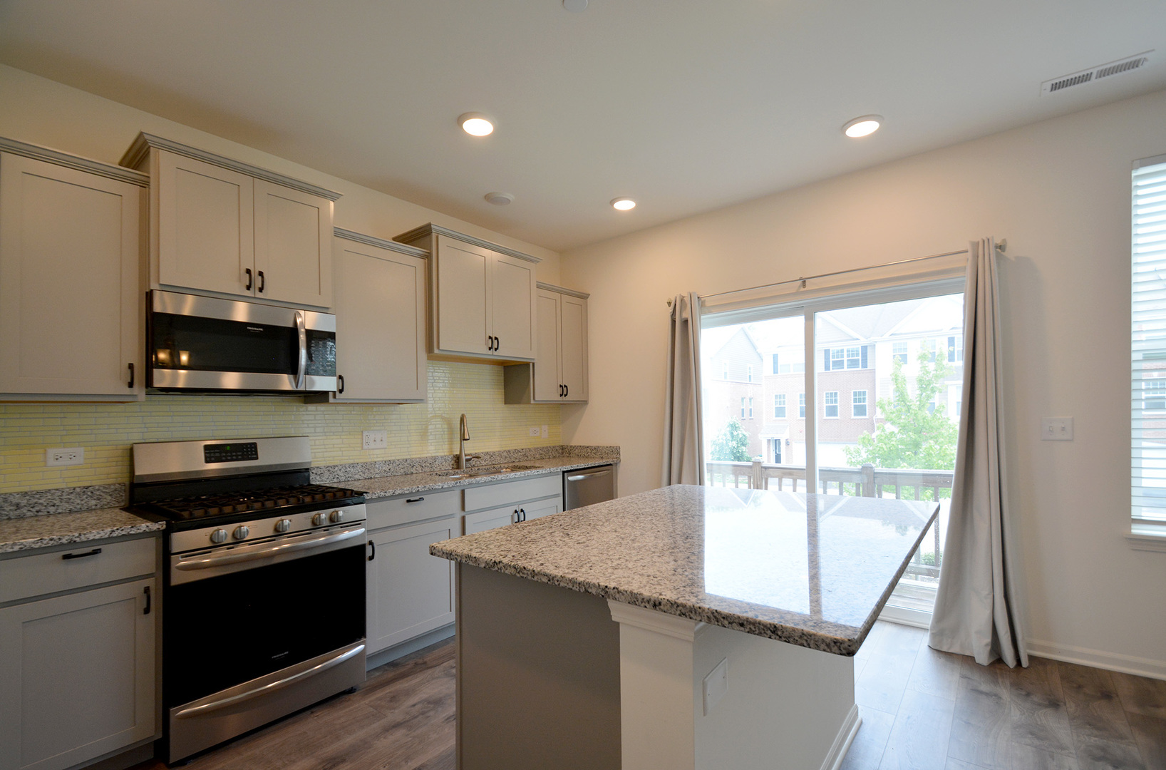 17 Grey Wolf Drive Wheeling, IL 60090 - Photo 4 of 25 a kitchen with stainless steel appliances granite countertop a stove a sink and a microwave