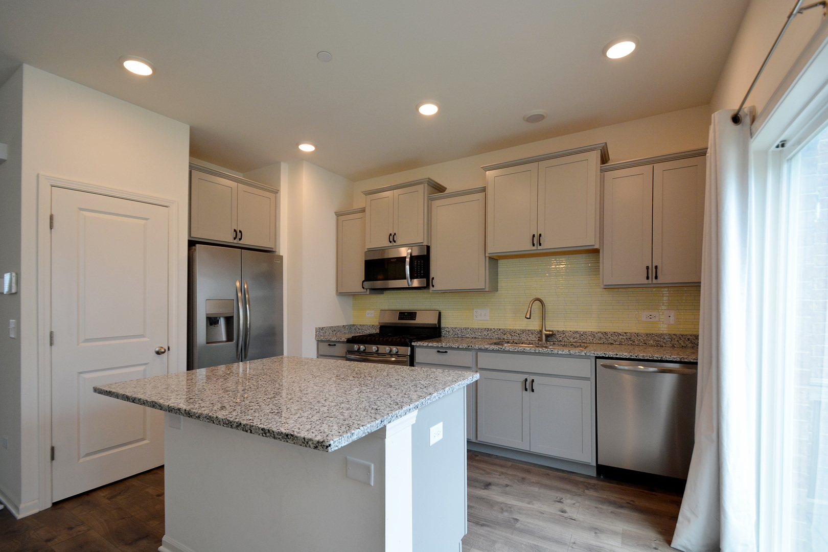 17 Grey Wolf Drive Wheeling, IL 60090 - Photo 6 of 25 a kitchen with a sink stainless steel appliances and white cabinets