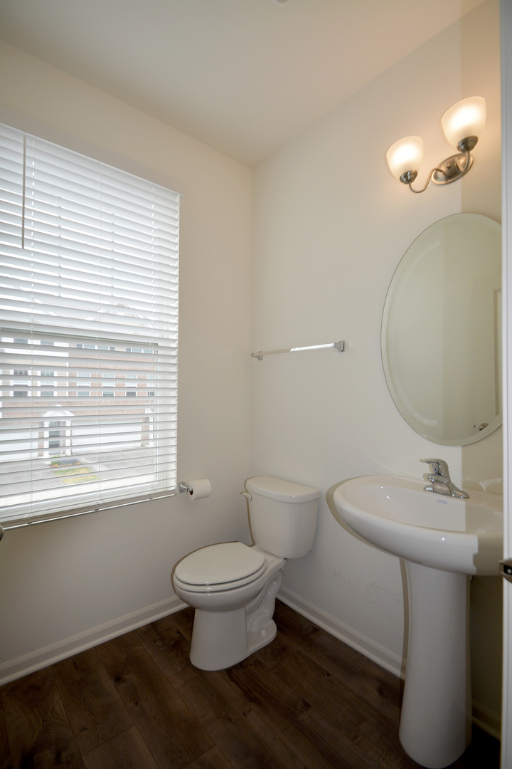 17 Grey Wolf Drive Wheeling, IL 60090 - Photo 9 of 25 a white toilet sitting next to a bathroom sink