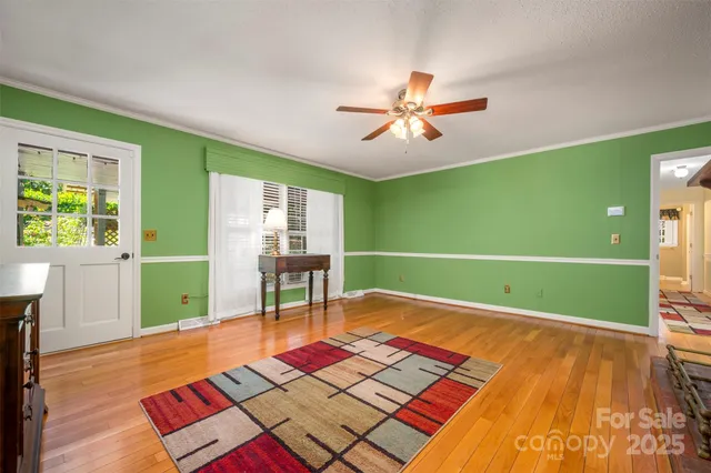 a room with pool table and windows