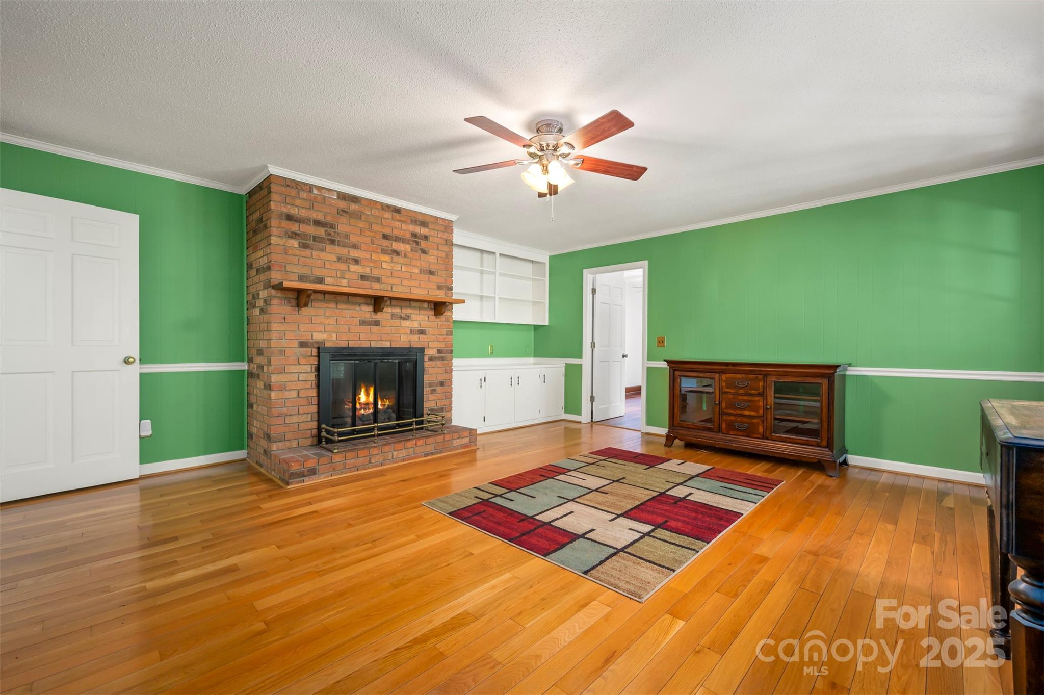 147 Anne Street Rutherfordton, NC 28139 - Photo 15 of 31 a living room with a fireplace and a flat screen tv