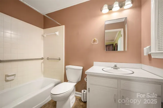 a bathroom with a granite countertop sink a toilet and a mirror