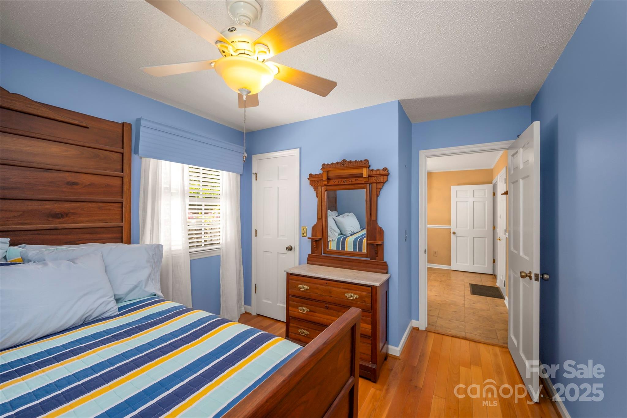 147 Anne Street Rutherfordton, NC 28139 - Photo 24 of 31 a bedroom with a bed and a chandelier