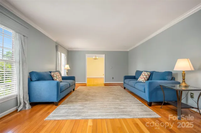 a living room with furniture and a lamp
