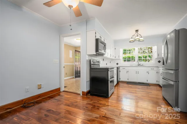 a kitchen with stainless steel appliances a stove top oven and a refrigerator
