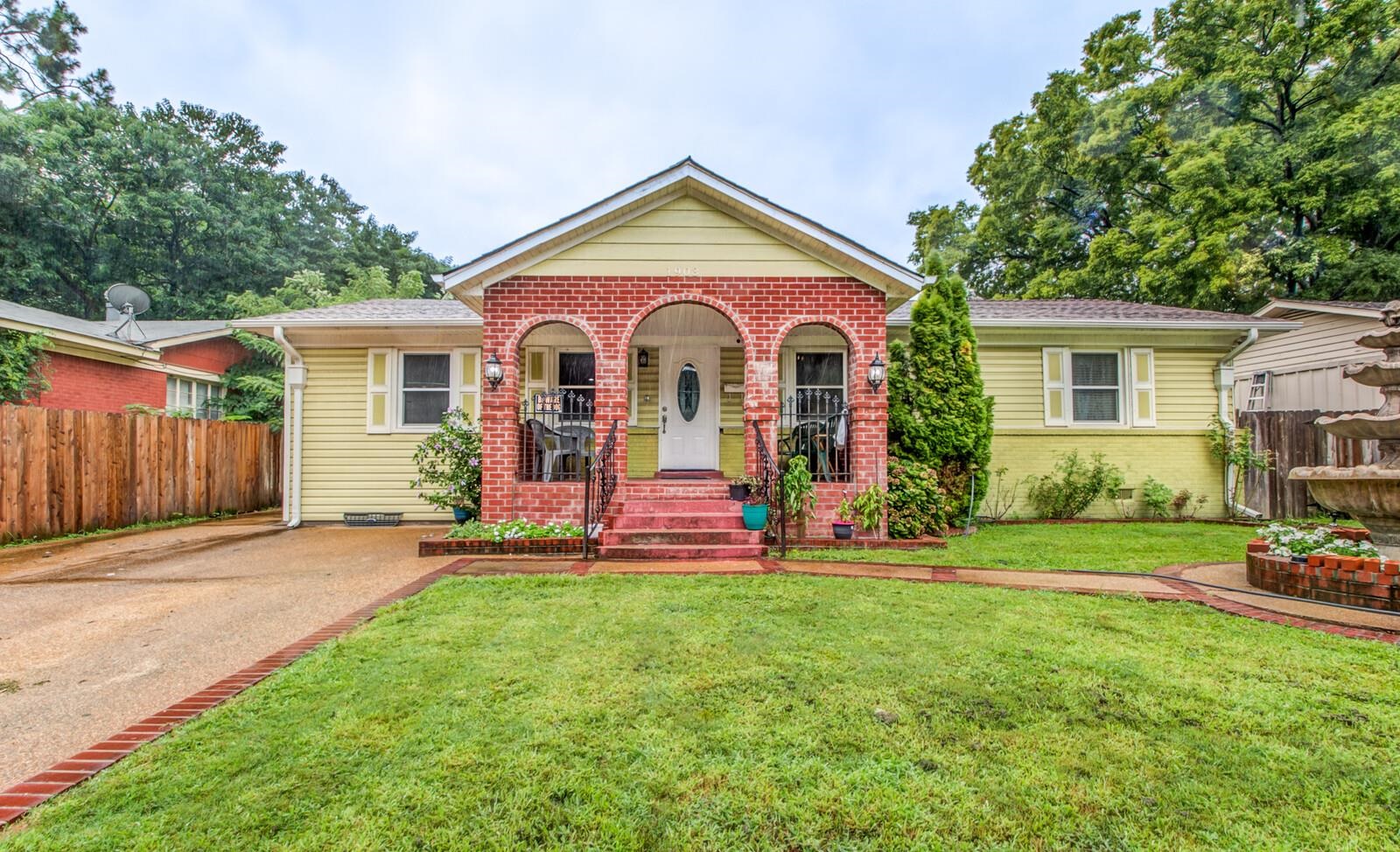 a front view of a house with a yard and porch