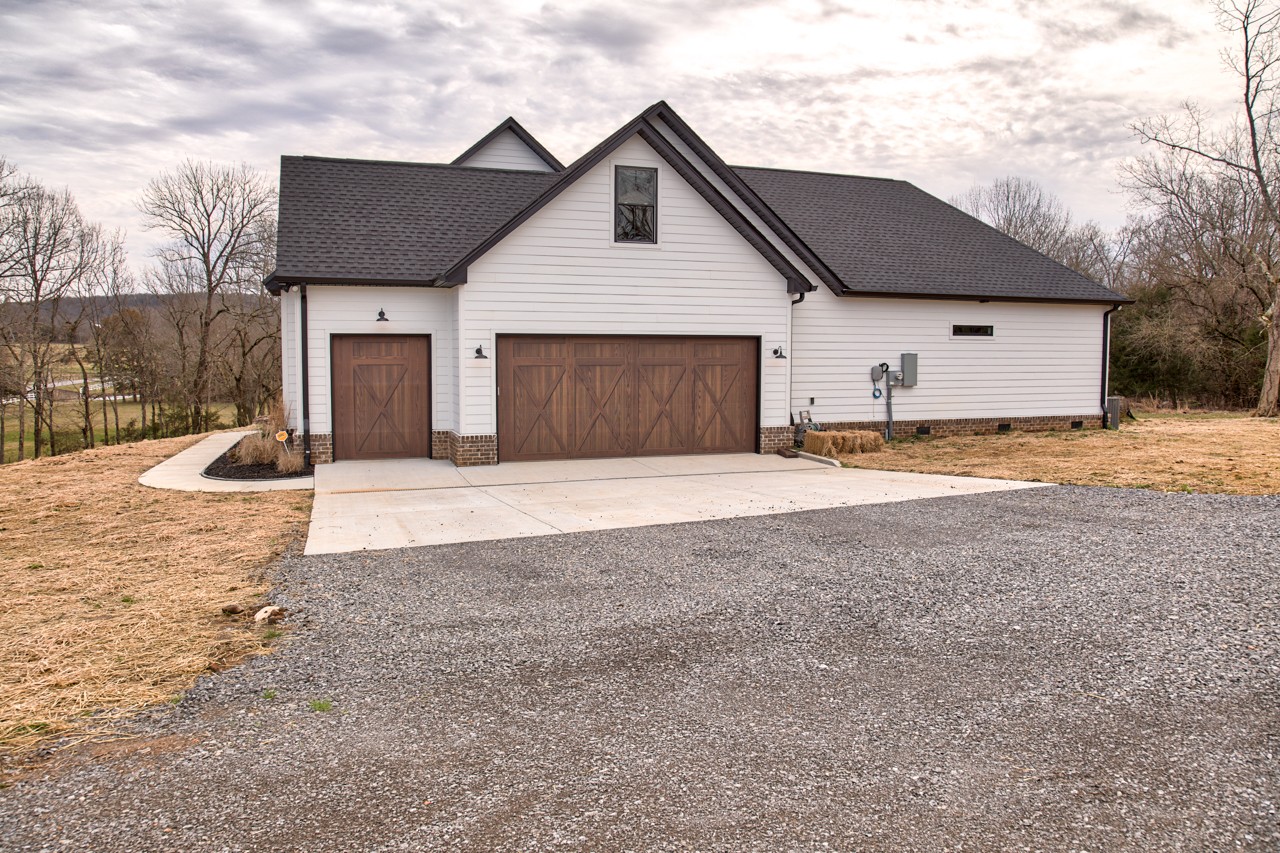 1190 Greenvale Road Milton, TN 37118 - Photo 2 of 21 a front view of a house with a yard and garage