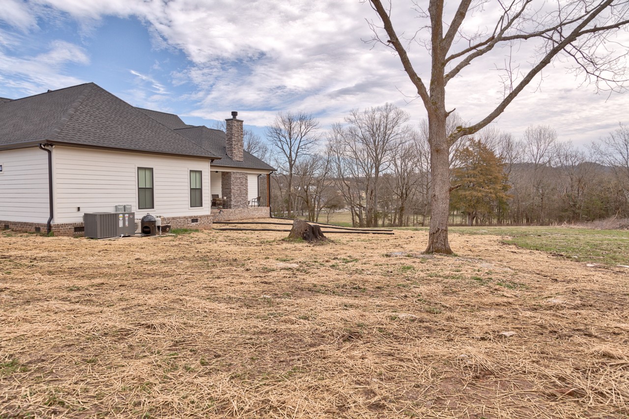 1190 Greenvale Road Milton, TN 37118 - Photo 20 of 21 a backyard of a house with trees and wooden fence