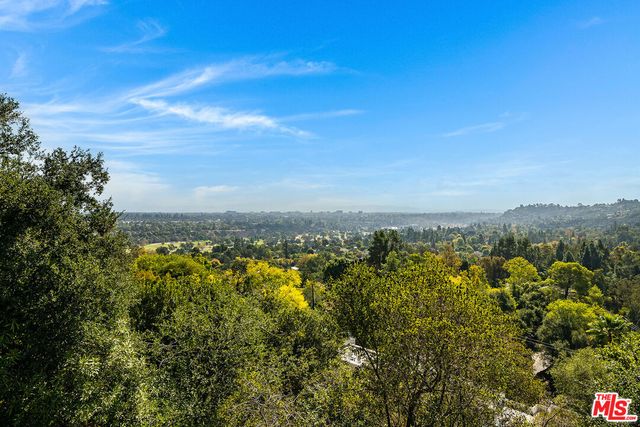 a view of a city with lush green forest