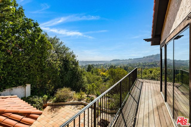 a view of a balcony with two chairs