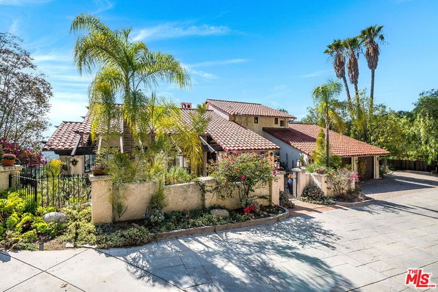a view of a backyard with potted plants