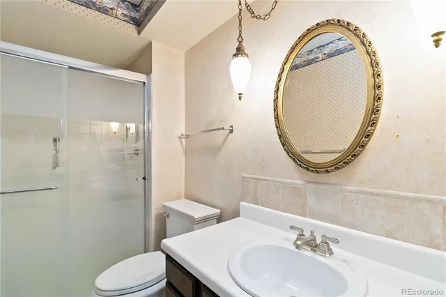 a bathroom with a sink a mirror and toilet