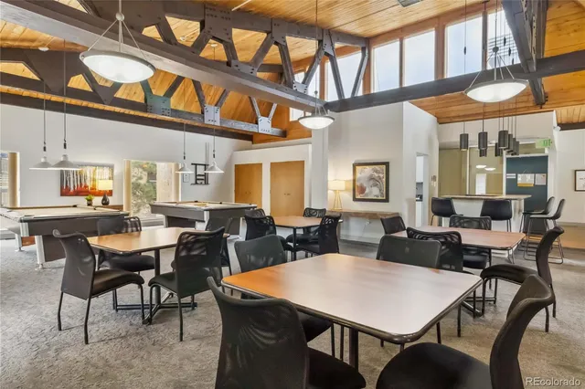 a room with pool table and windows