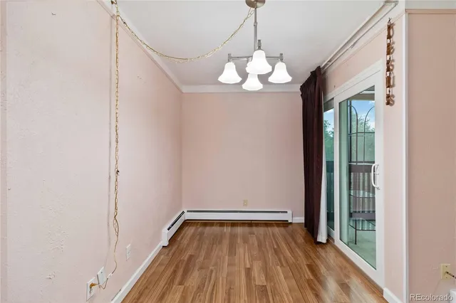 a view of a room with wooden floor fan and window