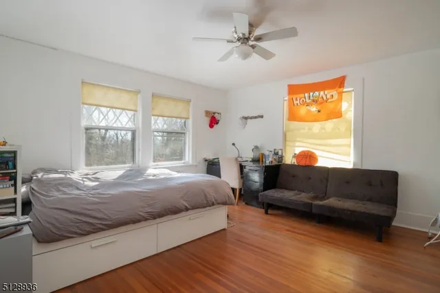 a bedroom with a bed couch and window