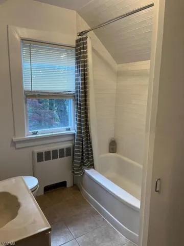 a bathroom with a tub and a shower