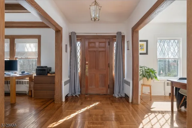 a view of a livingroom with furniture window and wooden floor