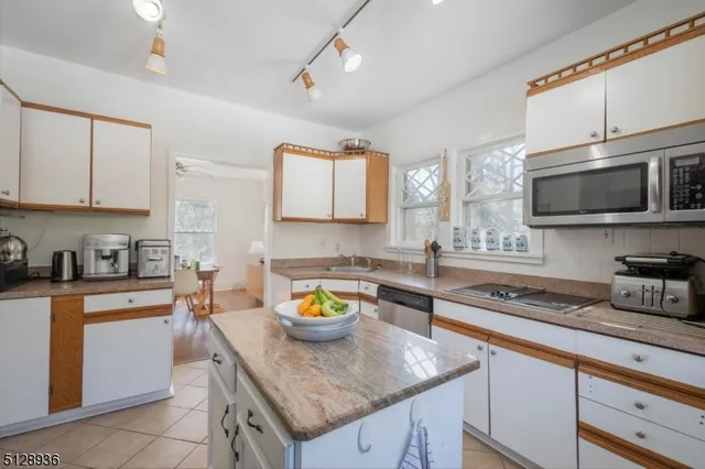 a kitchen with a sink a stove and cabinets