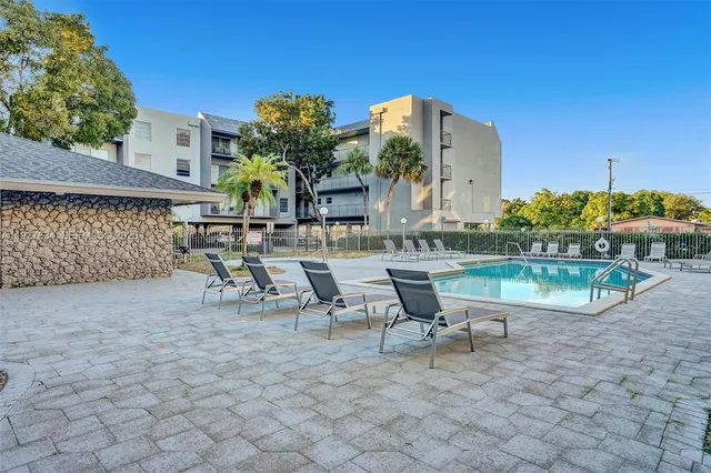 a view of a chairs and table in backyard