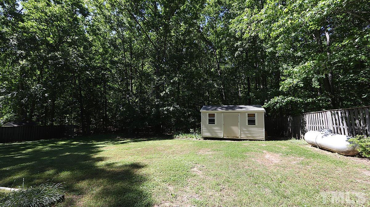 720 Torredge Road Durham, NC 27712 - Photo 16 of 17 a view of a white house with a yard and large trees