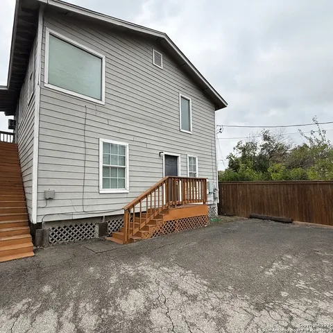 a view of a house with wooden fence