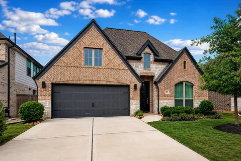 a front view of a house with garage