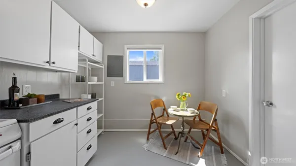 a utility room with cabinets washer and dryer