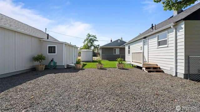 a view of a backyard with potted plants