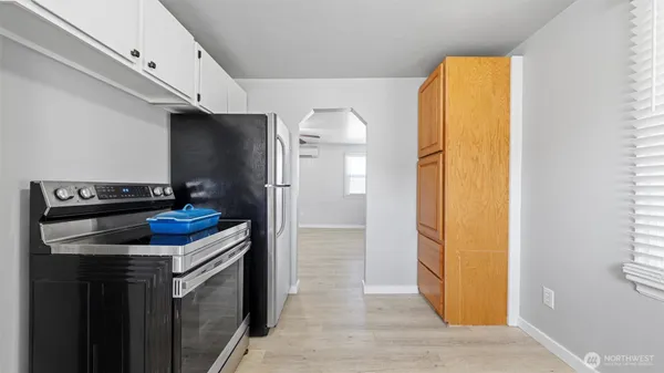 a kitchen with a refrigerator and a stove