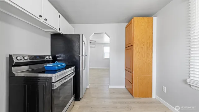 a kitchen with a refrigerator and a stove