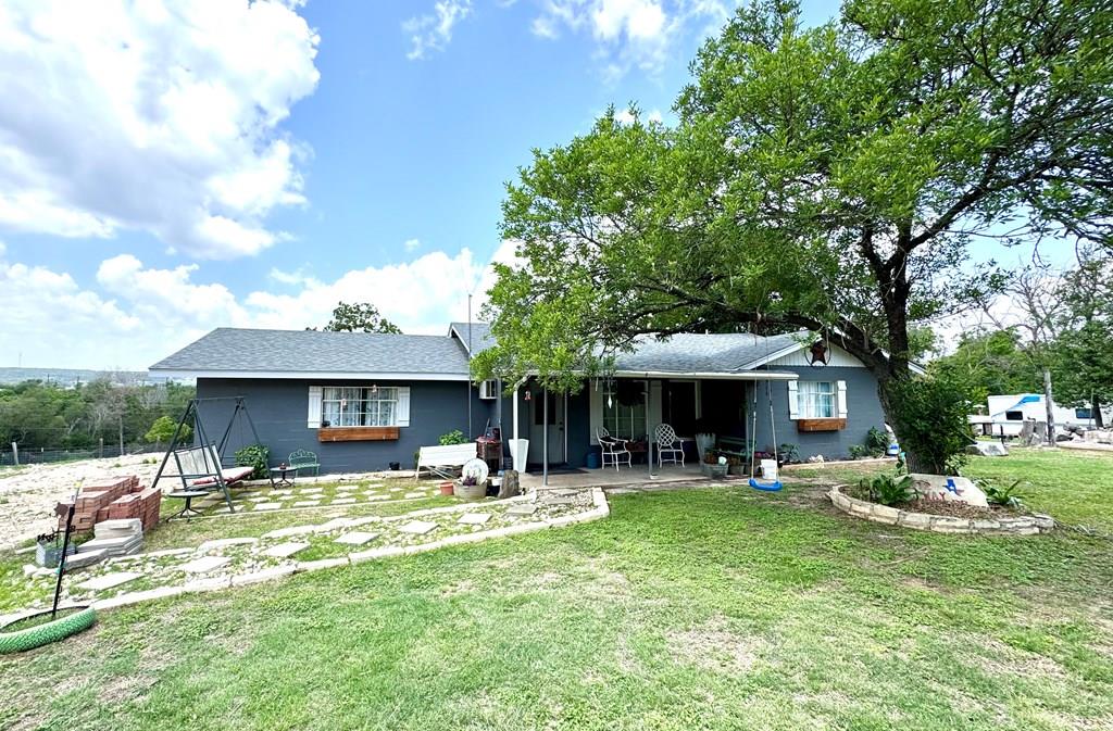 212 Way Drive Ingram, TX 78025 - Photo 1 of 22 a front view of a house with garden and trees