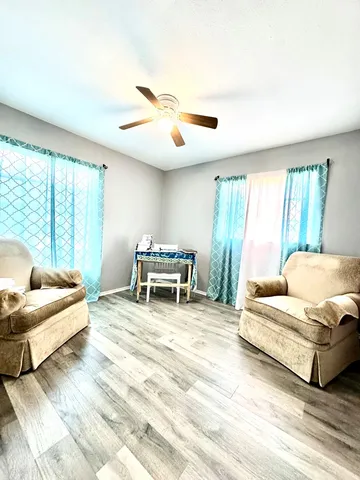a spacious bedroom with a bed and a large window