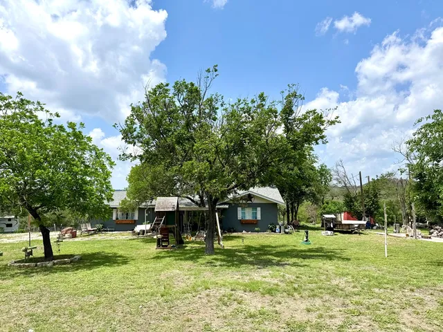 a view of a park with large trees