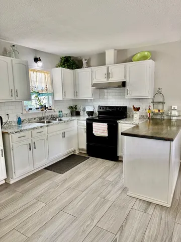 a kitchen with a sink cabinets and window