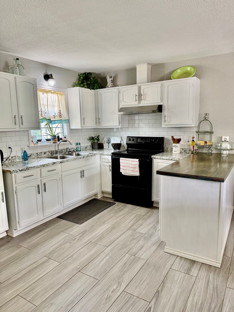 212 Way Drive Ingram, TX 78025 - Photo 7 of 22 a kitchen with a sink cabinets and window