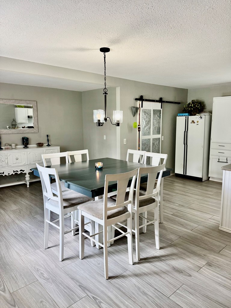 212 Way Drive Ingram, TX 78025 - Photo 8 of 22 a dining room with furniture a chandelier and wooden floor