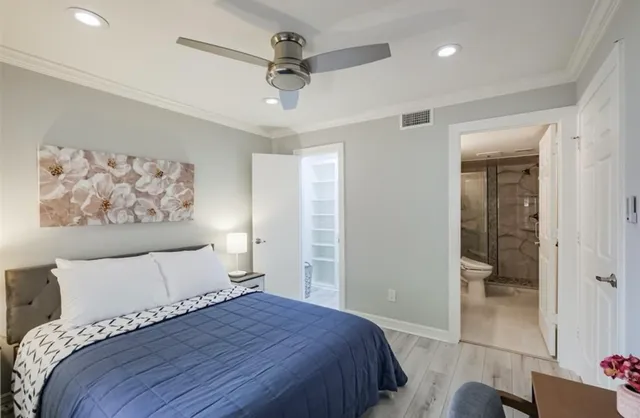 a very nice looking room with wooden floor and a chandelier fan
